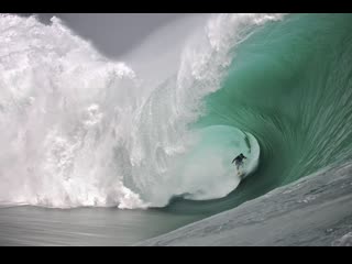 surfers in the mighty waves